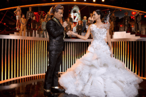 Host Caesar and a dressed up Katniss