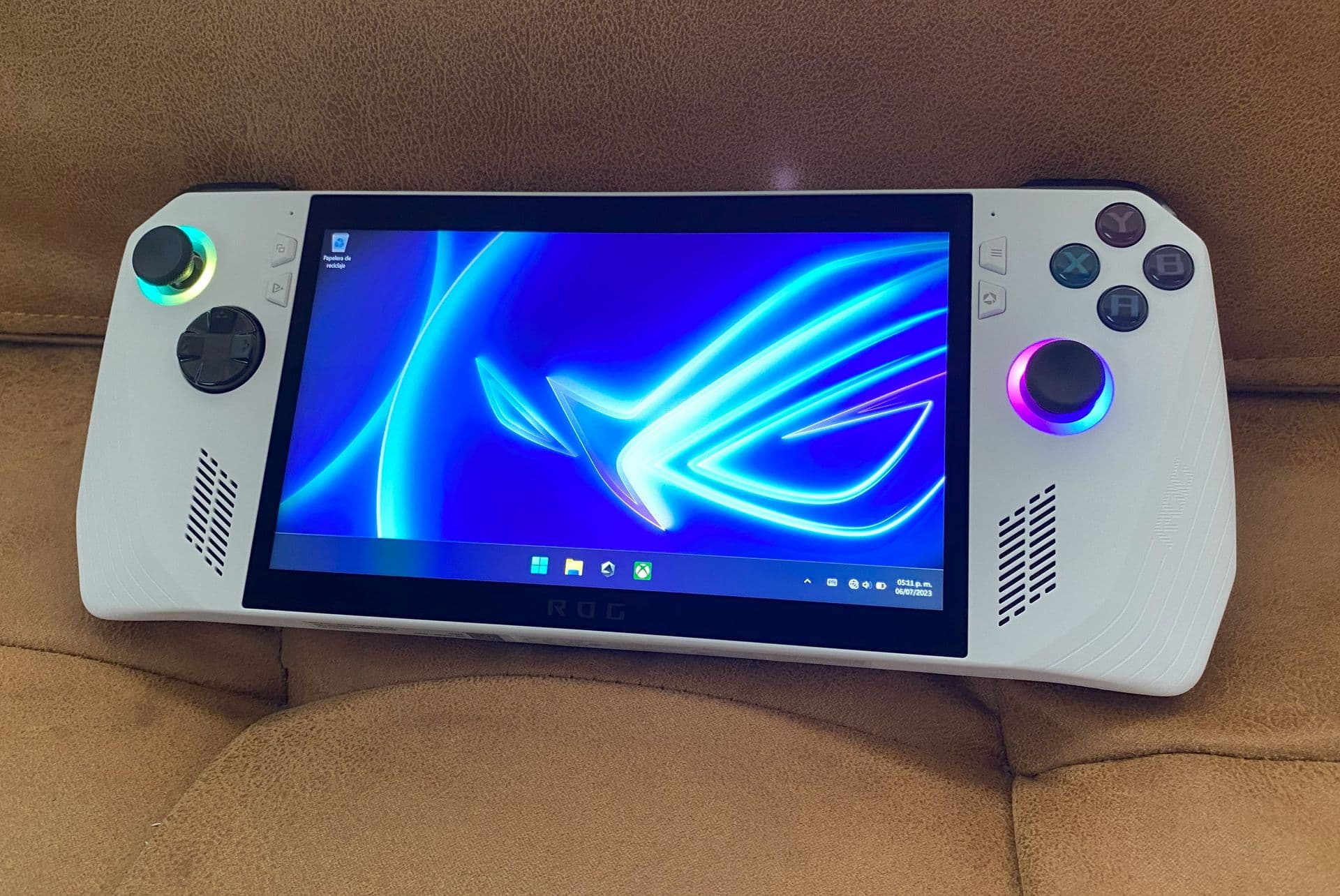 Handheld gaming device showcasing multiple game storefronts on its screen