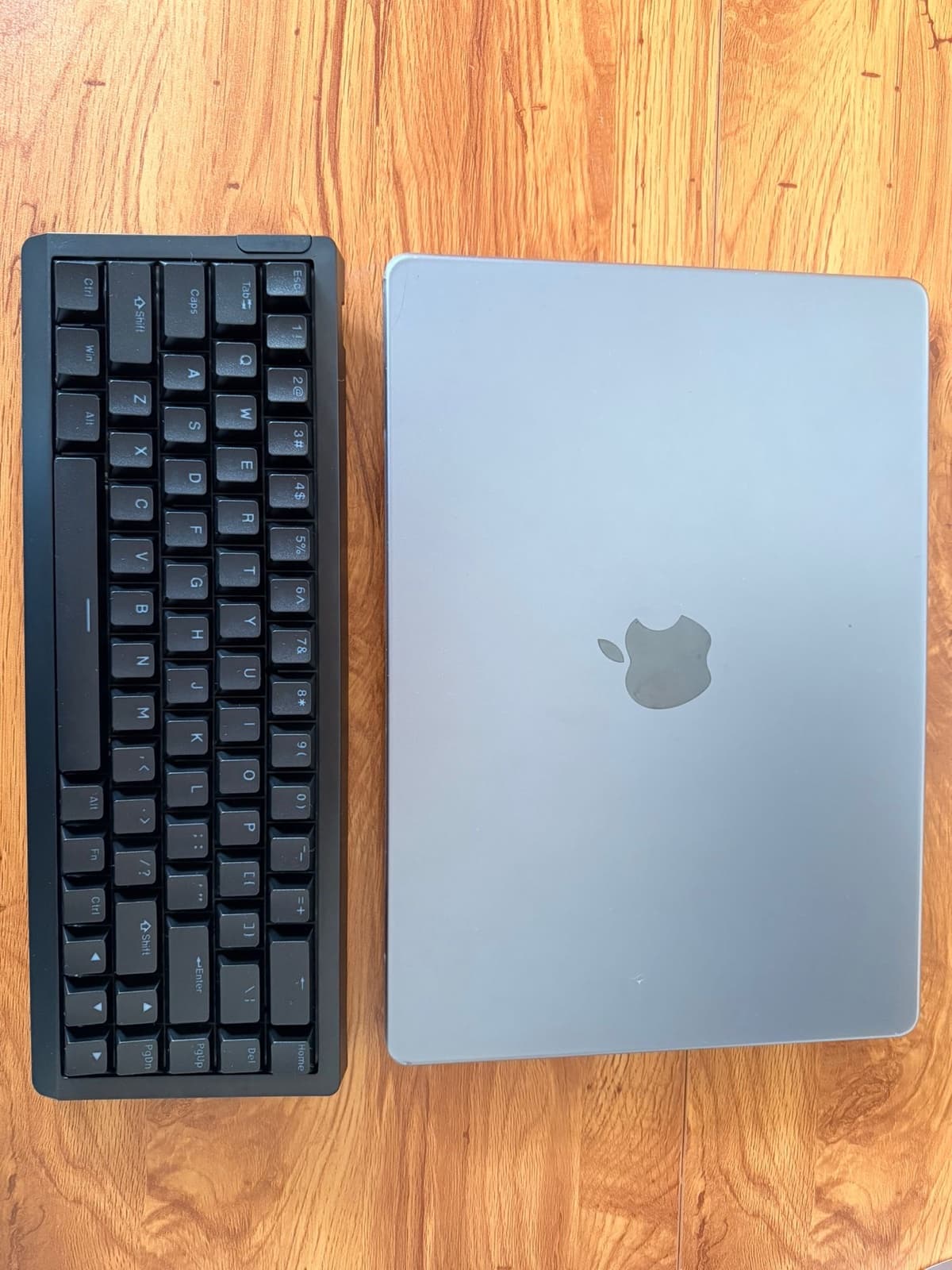 Epomaker HE68 Lite next to a MacBook Pro on a wooden desk, top-down view